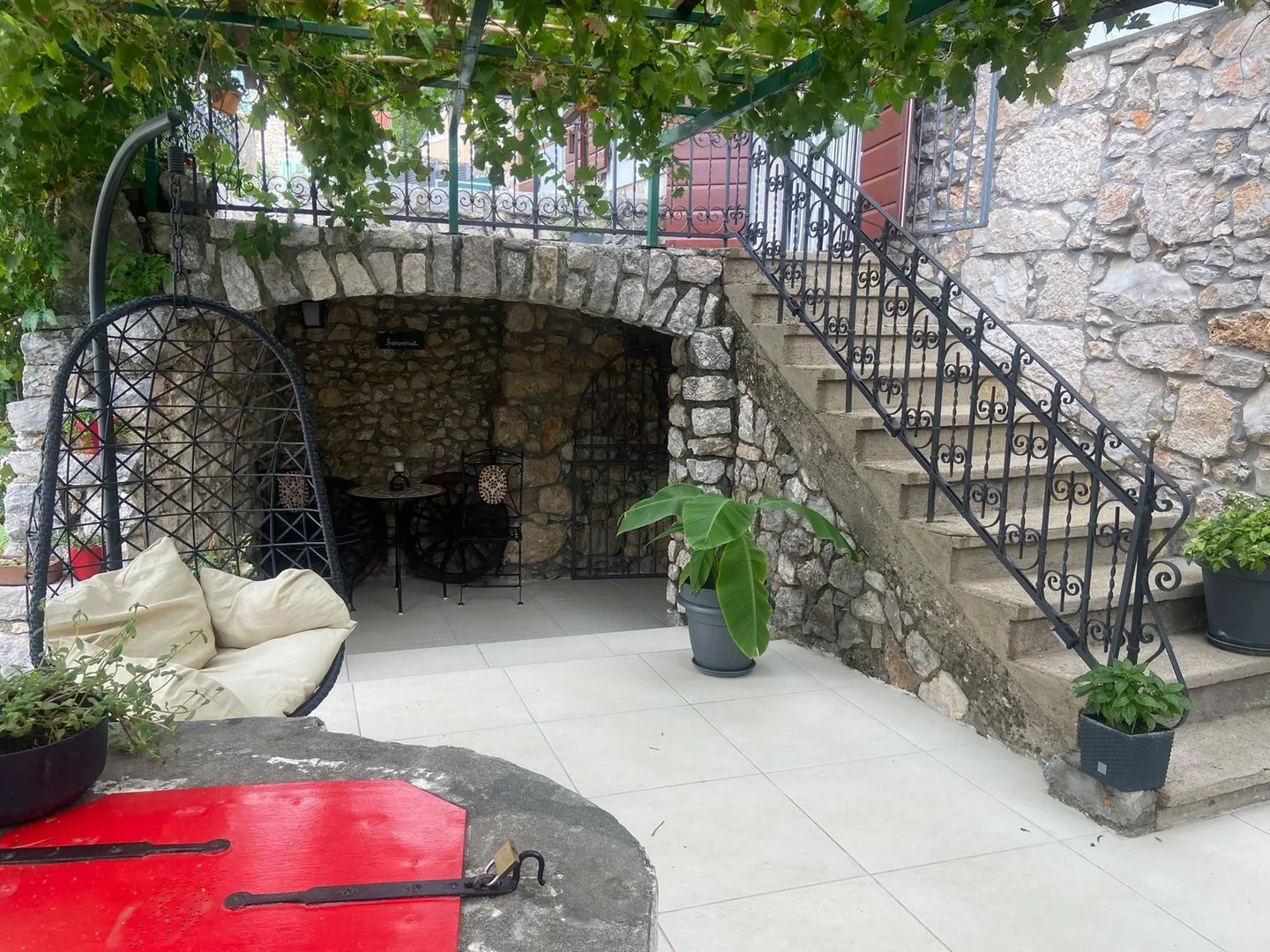 The alcove and the outside stairs under the vine