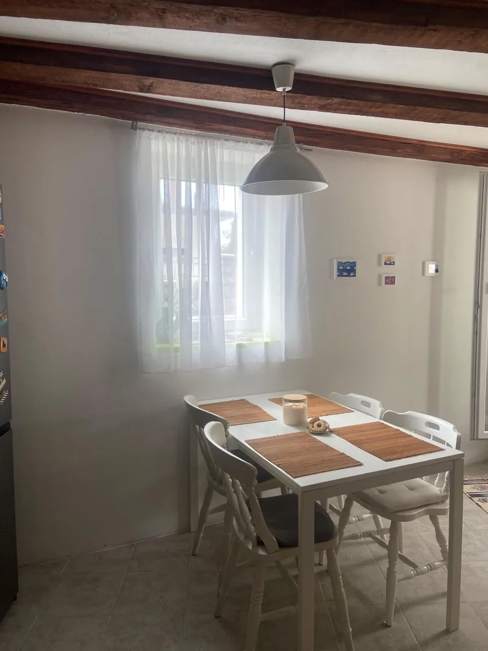 The dining table by the window in the kitchen