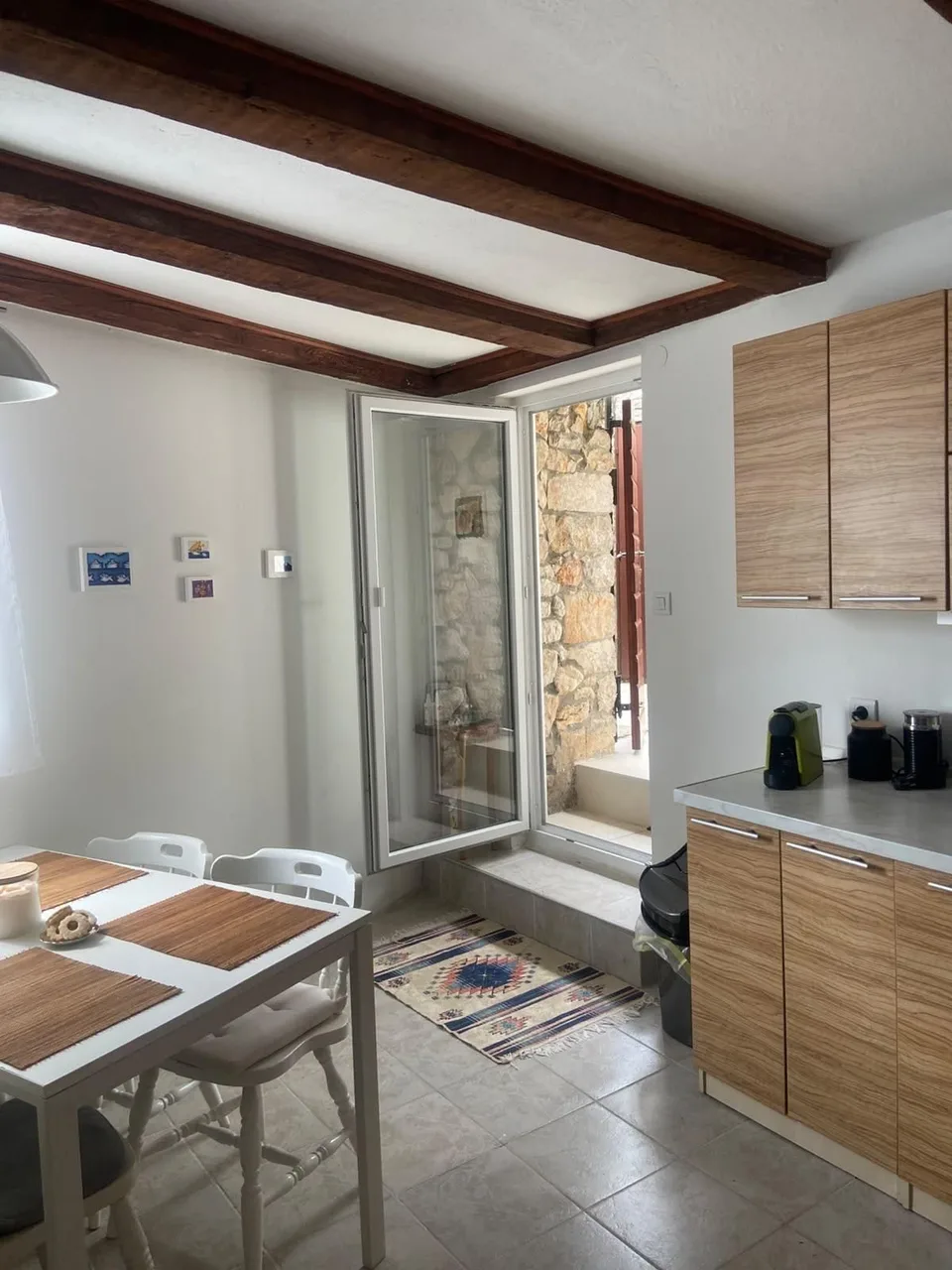 Kitchen and dining table, the door open to the outside