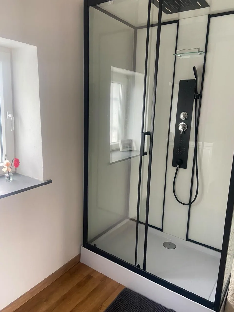 The glass shower enclosure in the upstairs bathroom