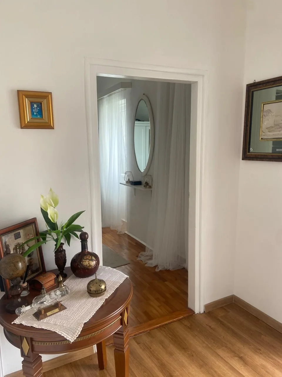 A small table with flowers in the hallway